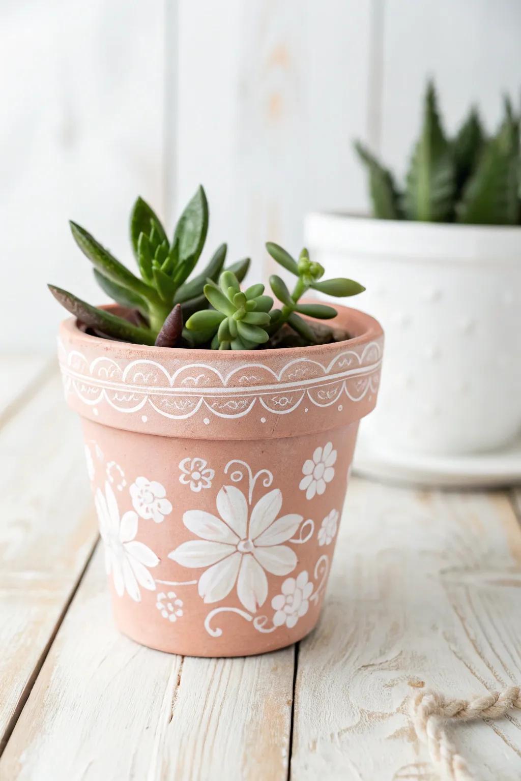 Add a touch of nature and artistry to your space with these charming painted terra cotta planters.