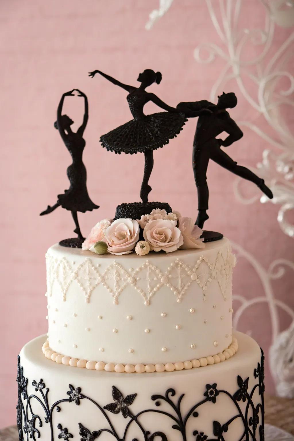 Cake with black dancer silhouettes on a pastel background.