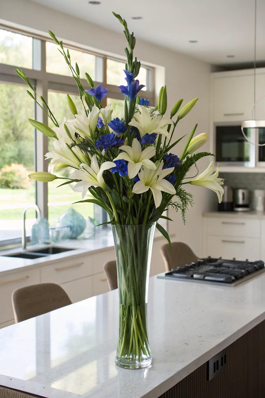 Elegant tall vase arrangement with irises and lilies.