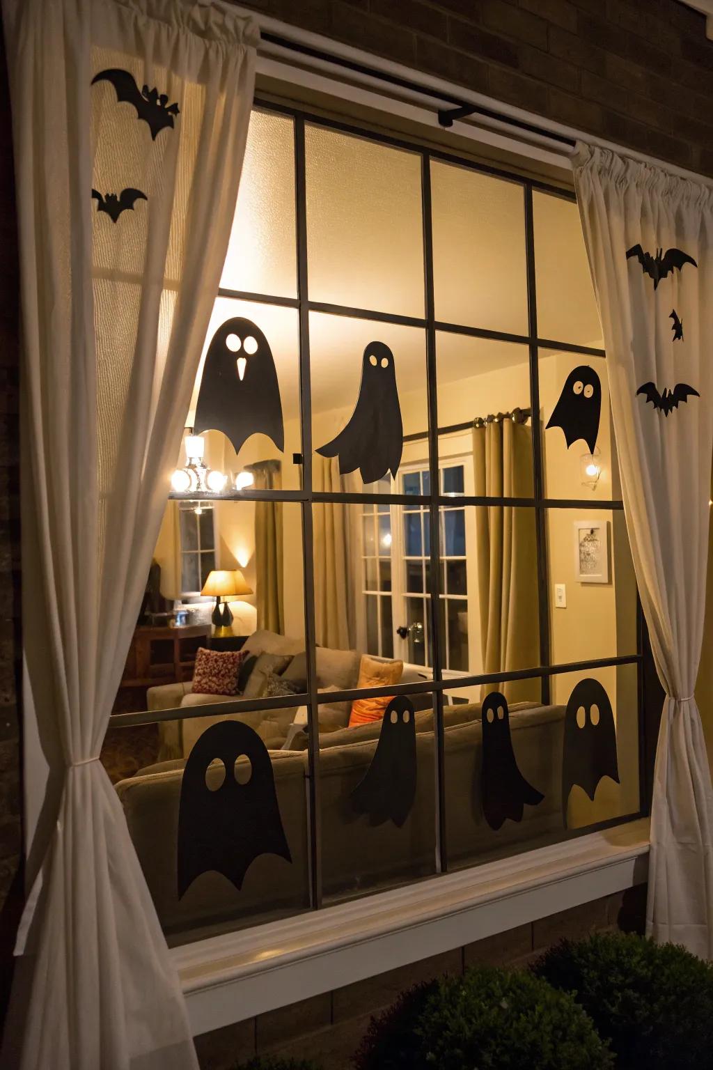 Ghost silhouettes add a spooky touch to any window.