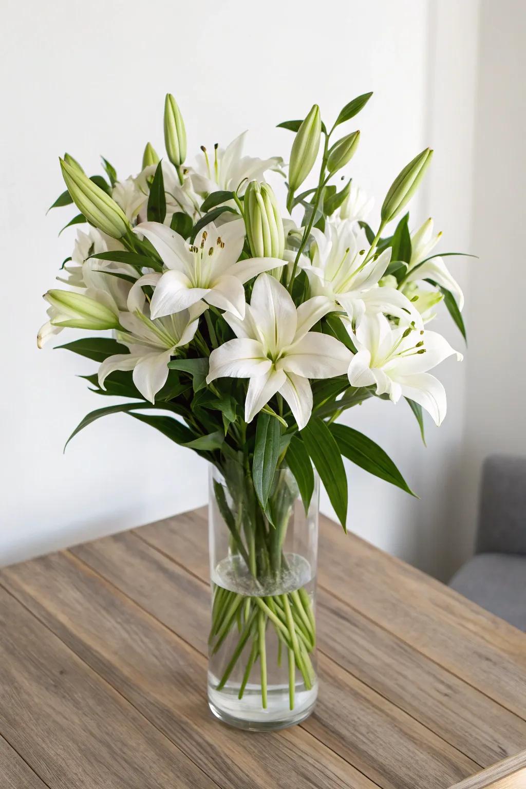 Classic white lilies in a clear vase for a timeless look.