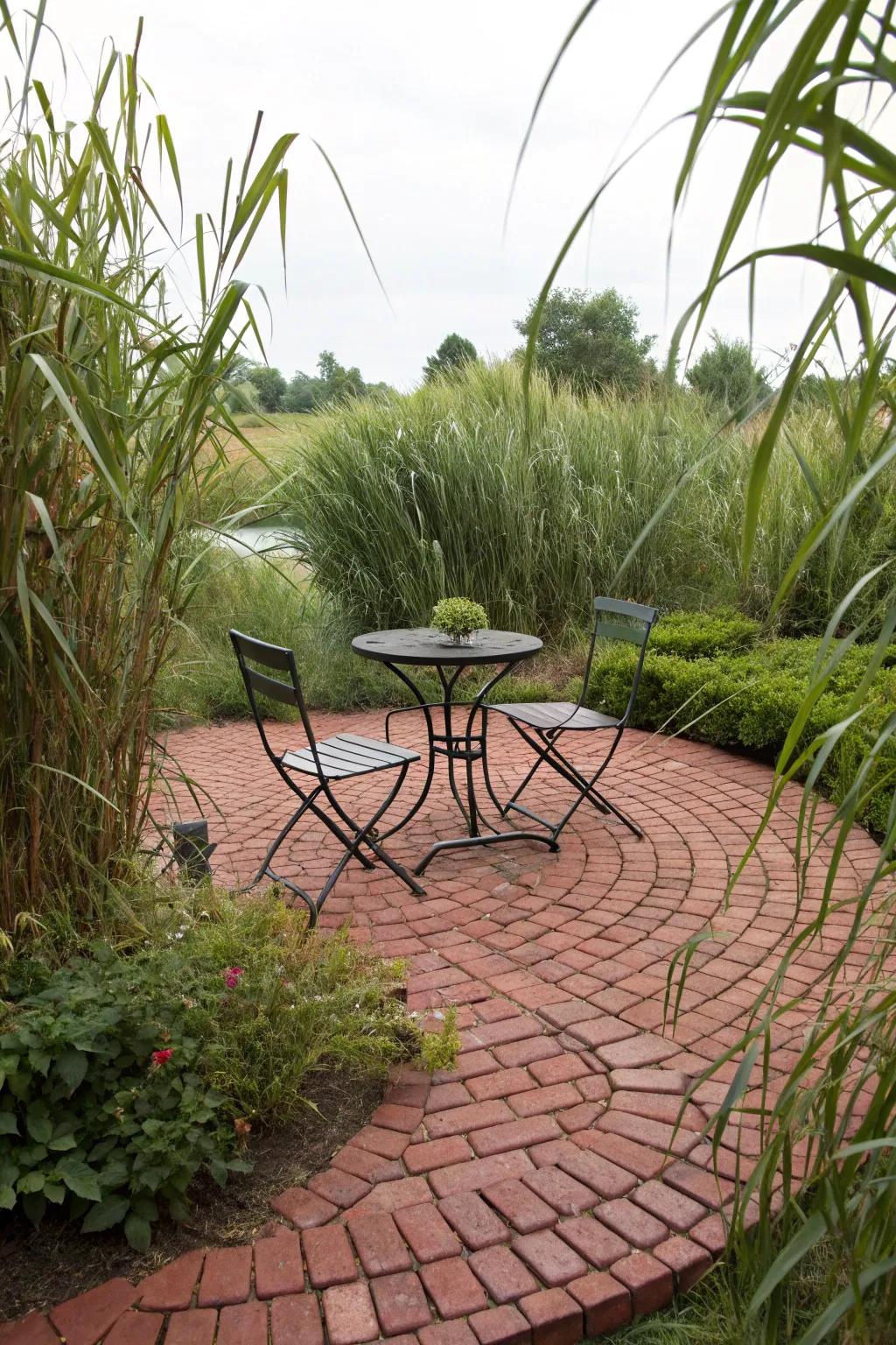 A circular brick patio with a bistro set, surrounded by tall plants.