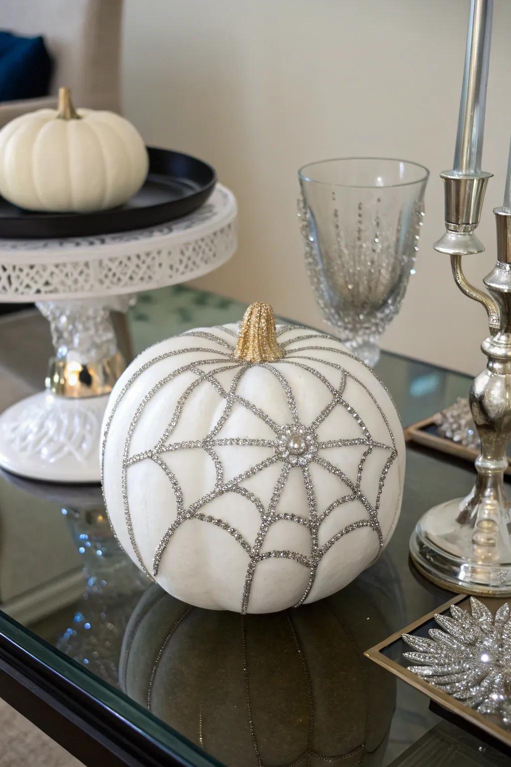 A faux pumpkin with a sparkling rhinestone spider web.