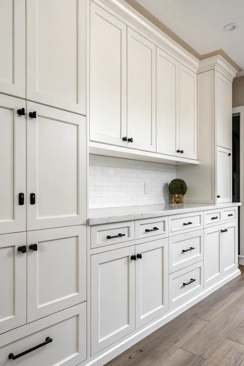 Minimalistic black pulls on white cabinets add a touch of elegance.