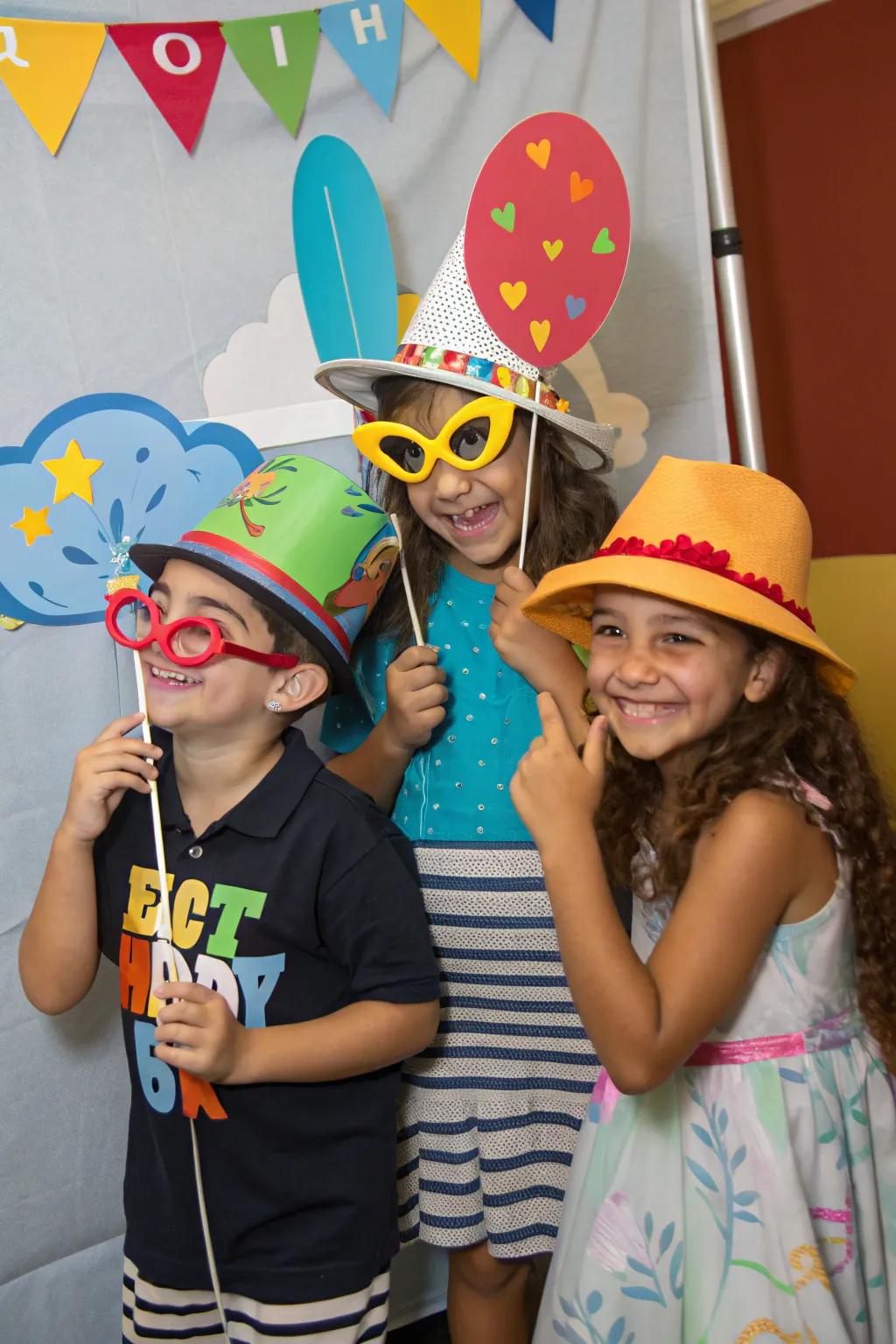 Kids striking poses at a photo booth.