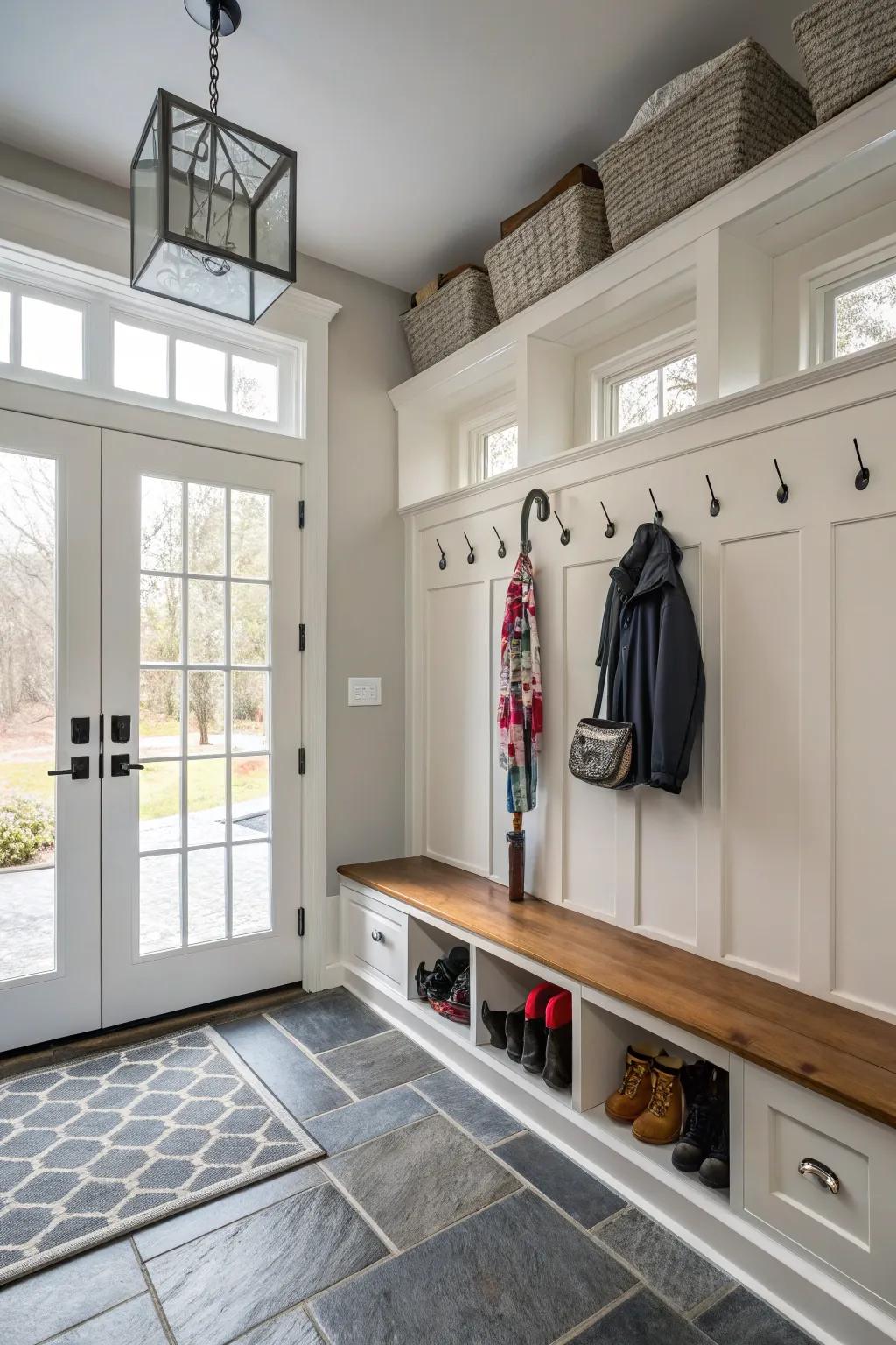 An umbrella holder keeps wet umbrellas organized in a garage mudroom.