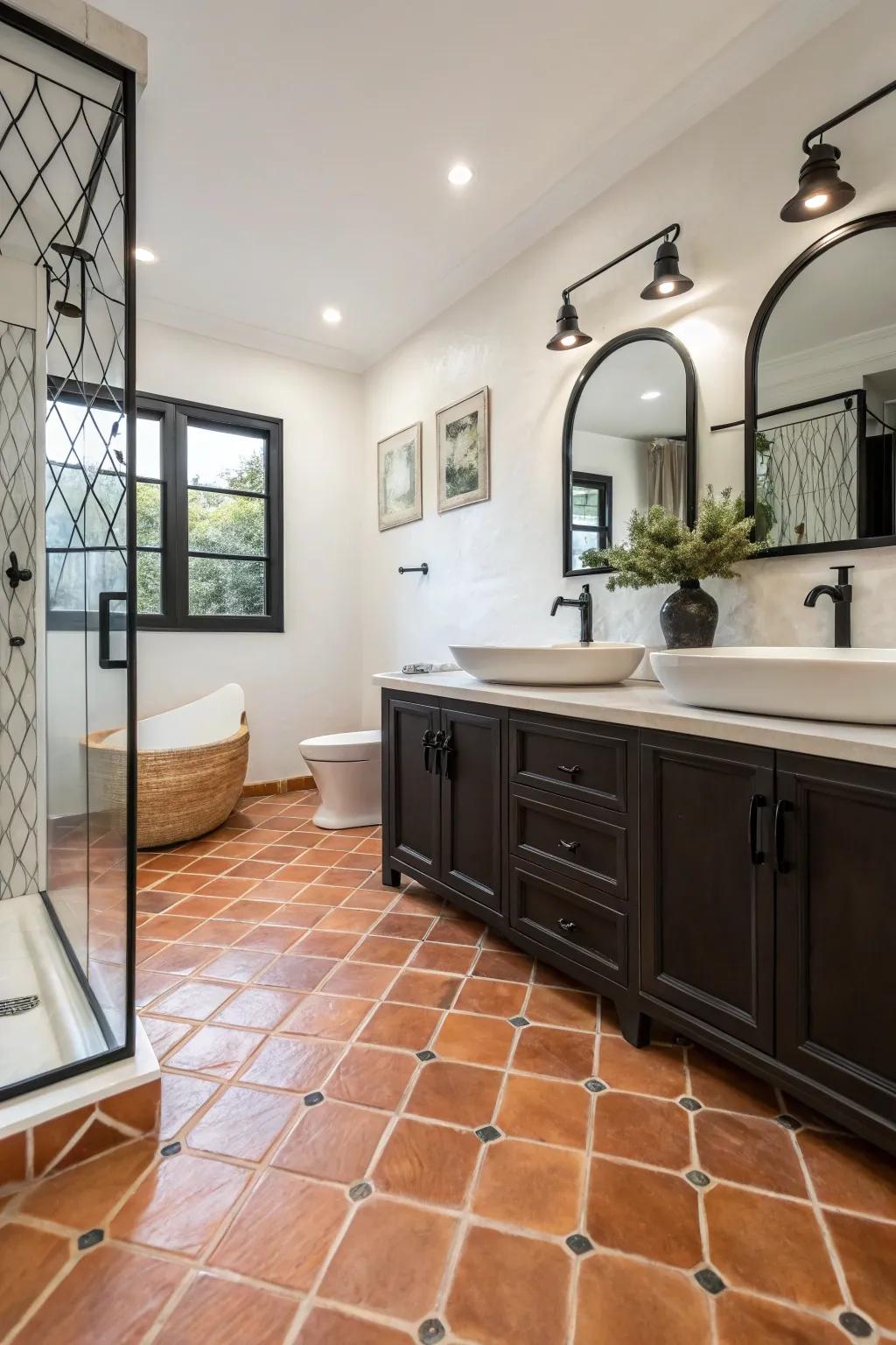 A contemporary bathroom with Saltillo tile flooring and striking black fixtures.