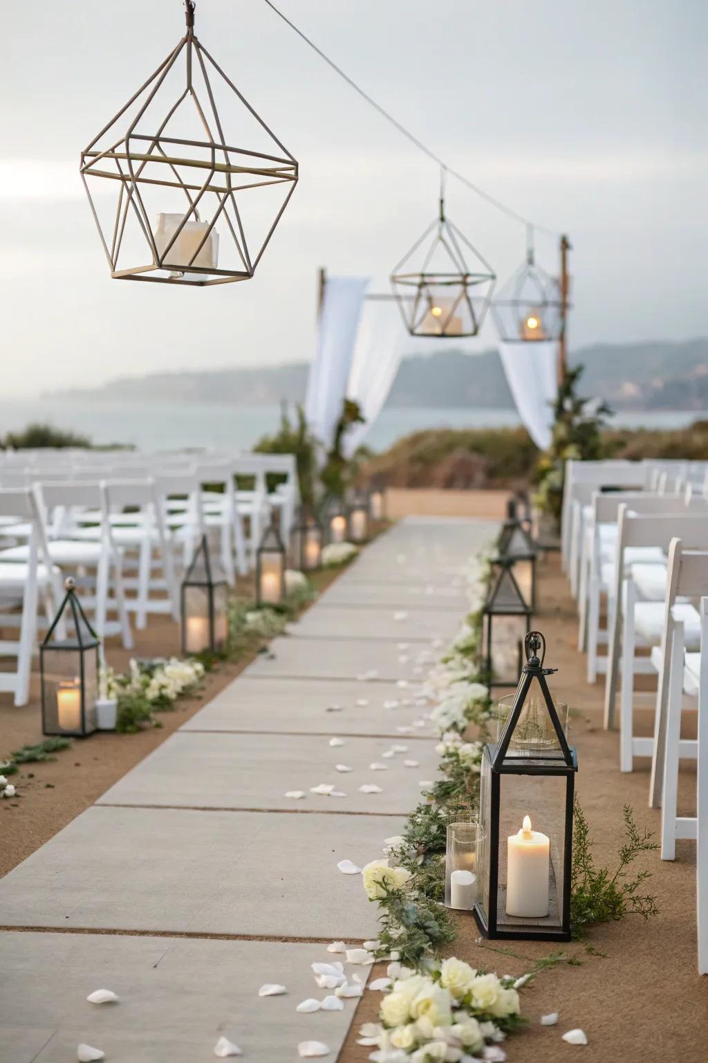 Modern geometric lanterns illuminate a wedding aisle.