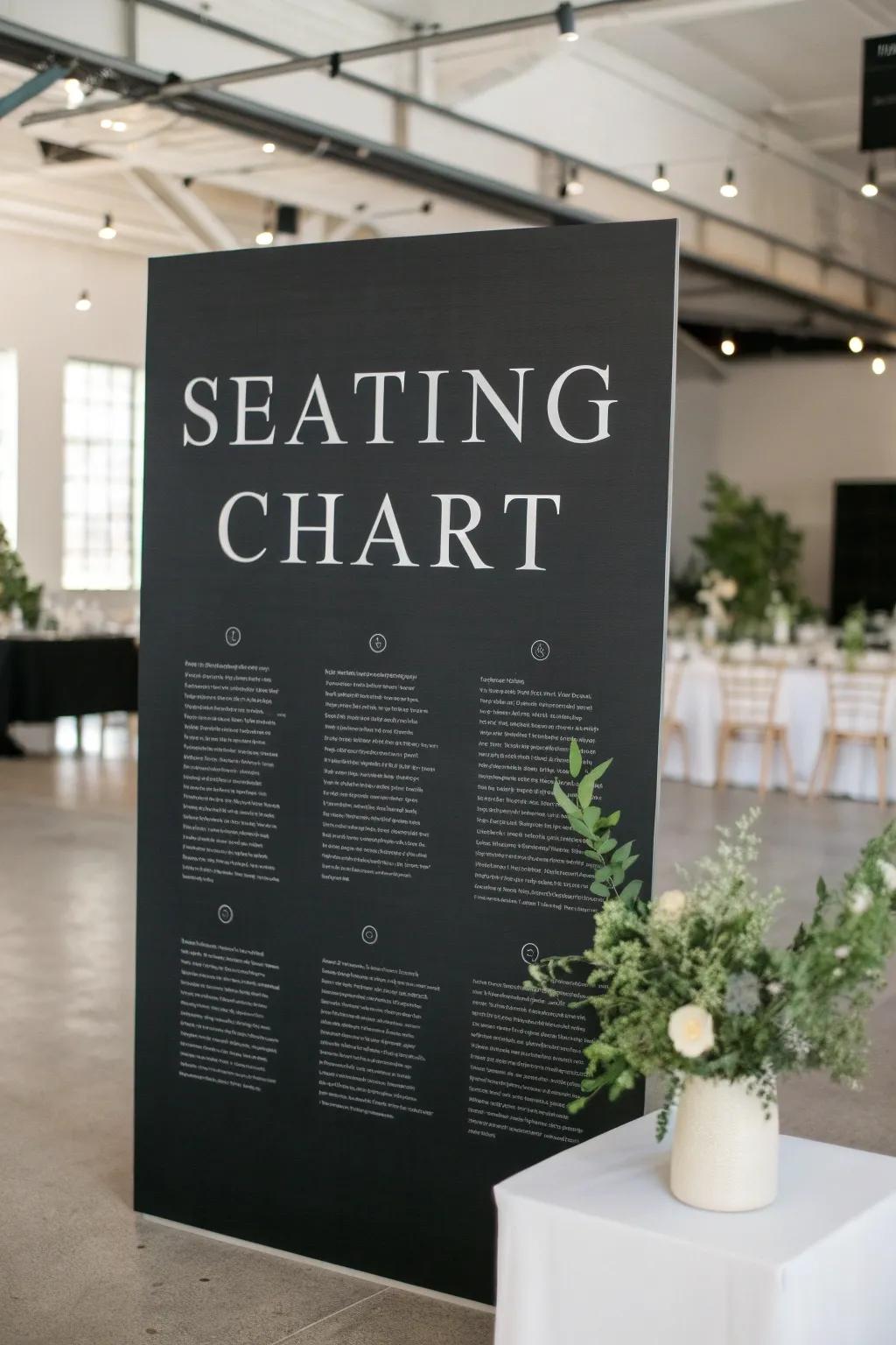 A sleek black board seating chart with crisp white lettering, perfect for a modern wedding aesthetic.