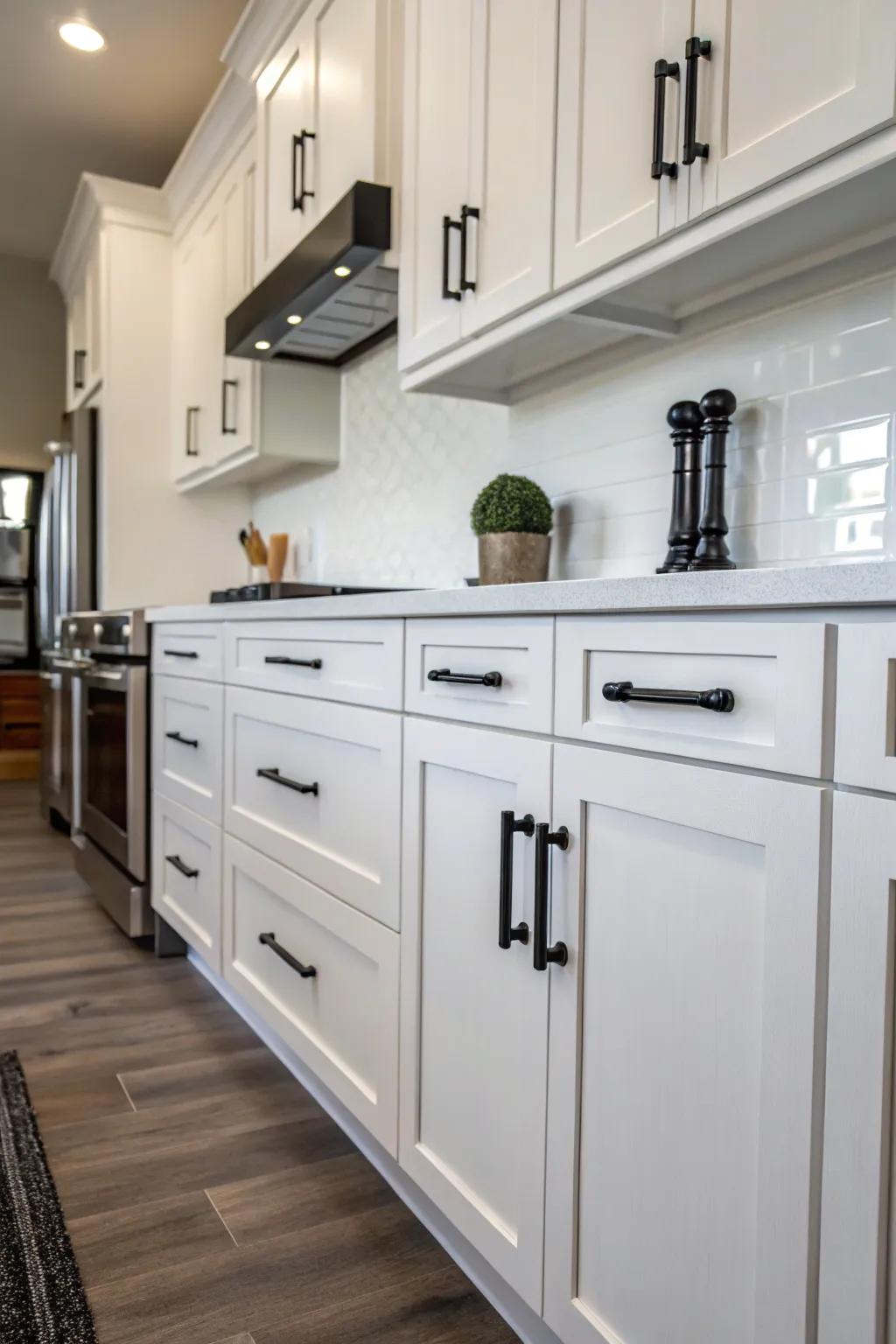 Contemporary kitchen with sleek black hardware on white cabinets.