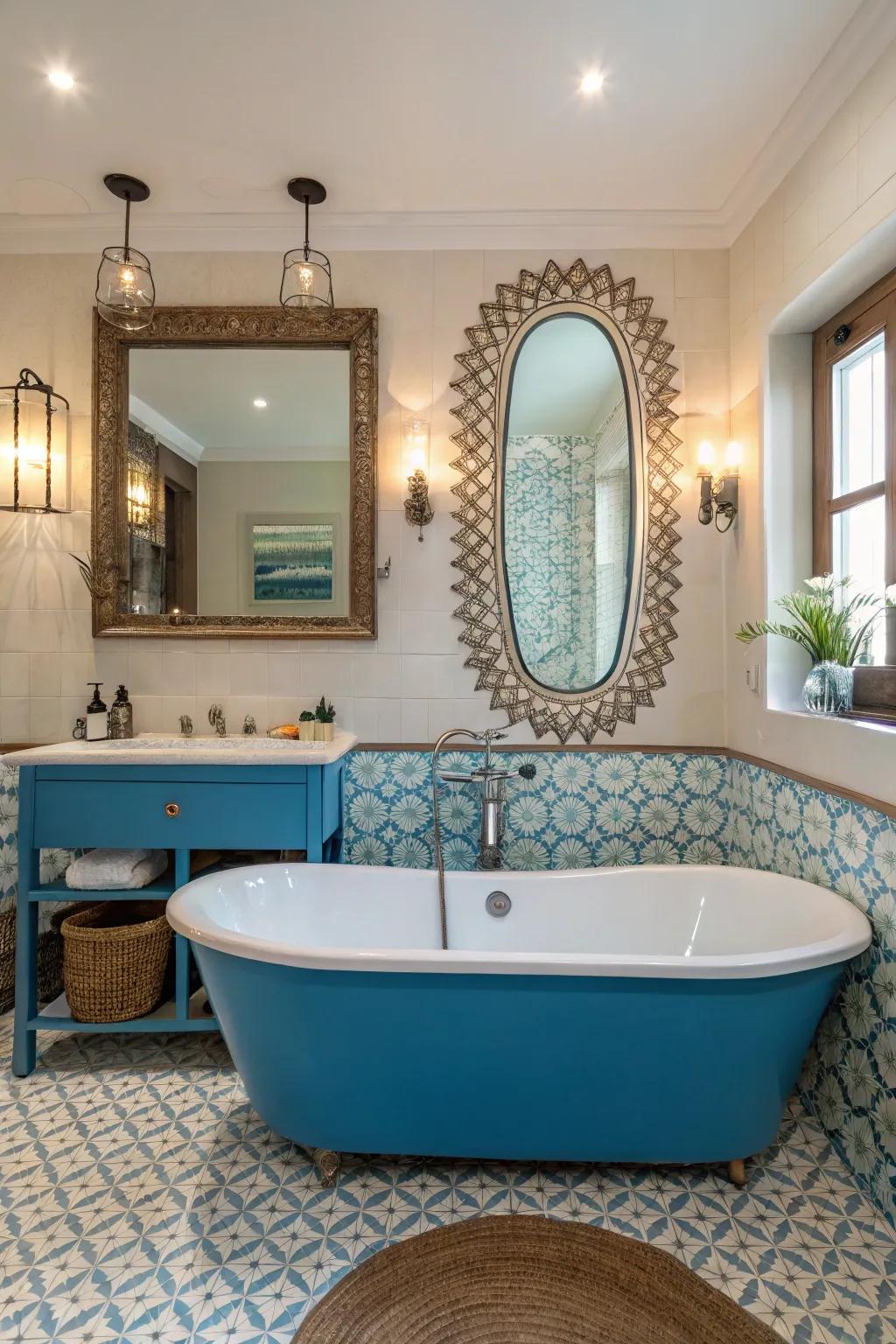 Mirrors enhance the light and space around a blue bathtub.