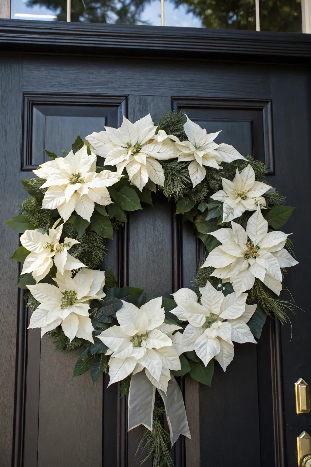 A sleek monochrome white poinsettia wreath on a dark door.