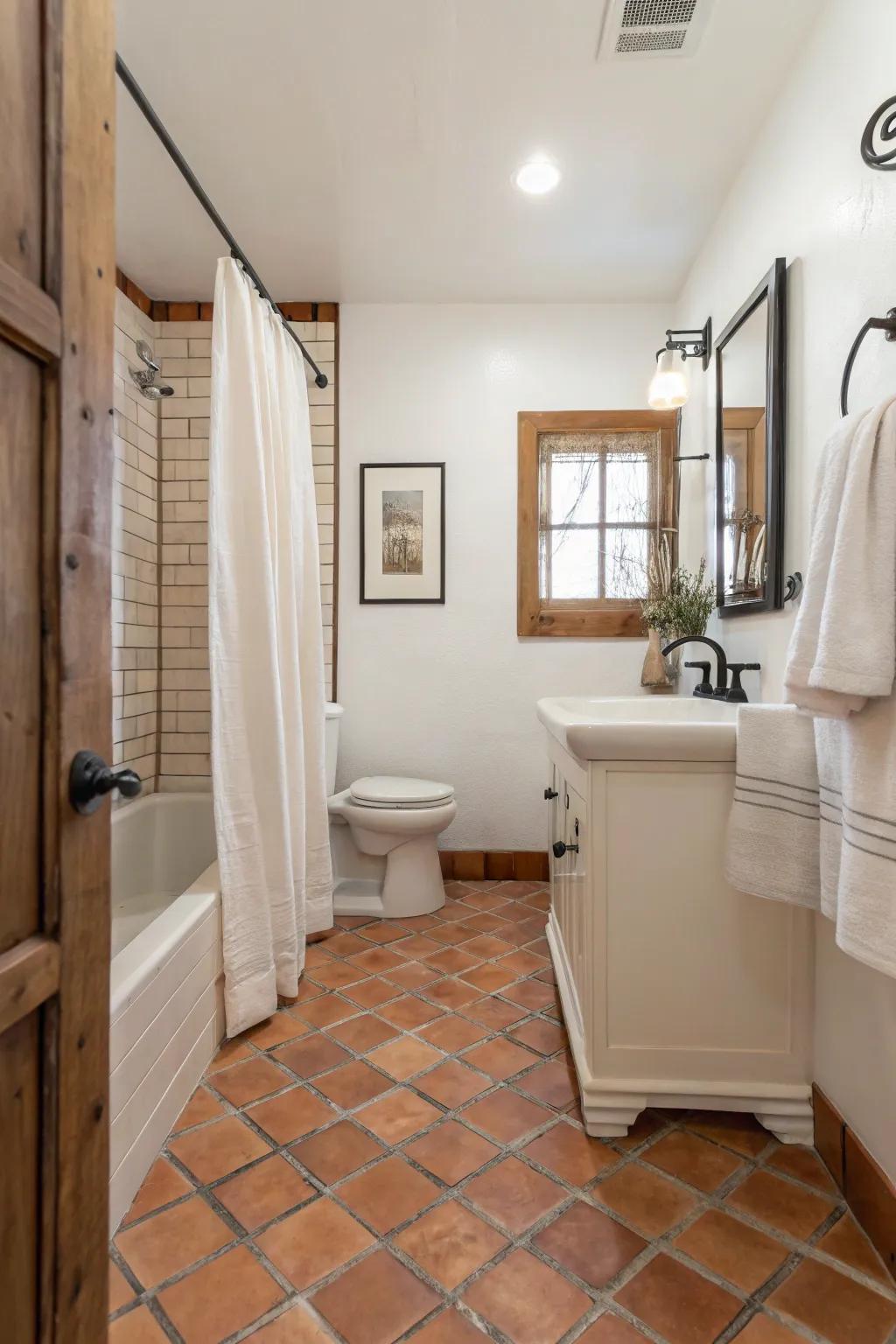 A minimalist bathroom featuring Saltillo tile flooring and soothing neutral tones.