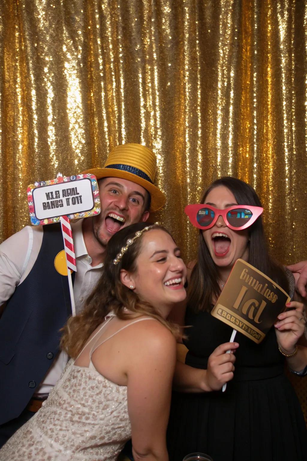 A photo booth with gold props adds fun and interaction to the celebration.