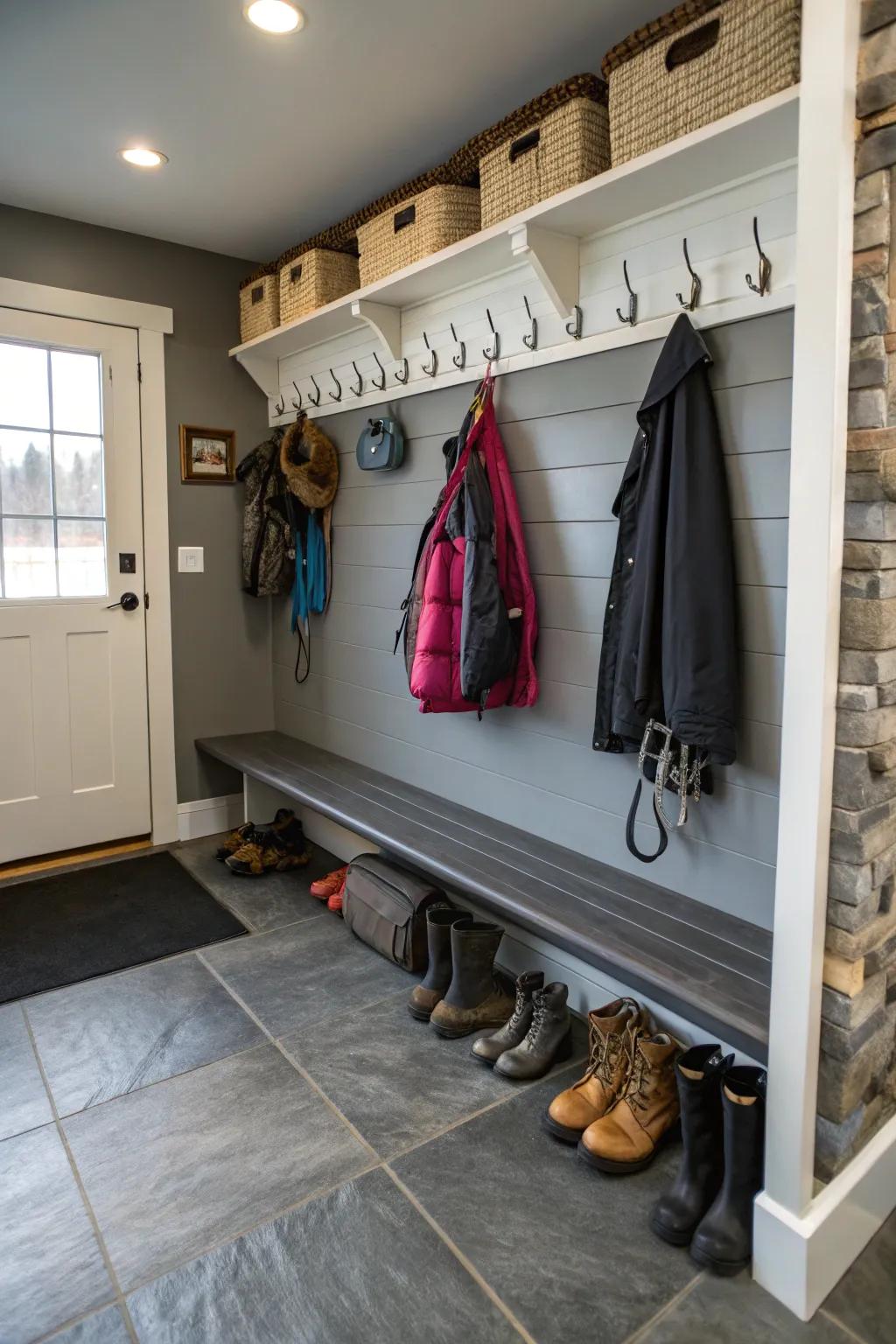 Hooks for pet gear keep leashes and coats organized in a garage mudroom.