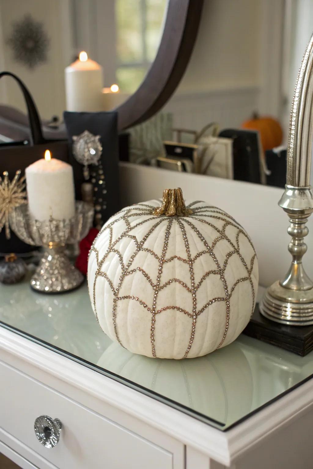 A pumpkin with a glamorous sequined spider web.