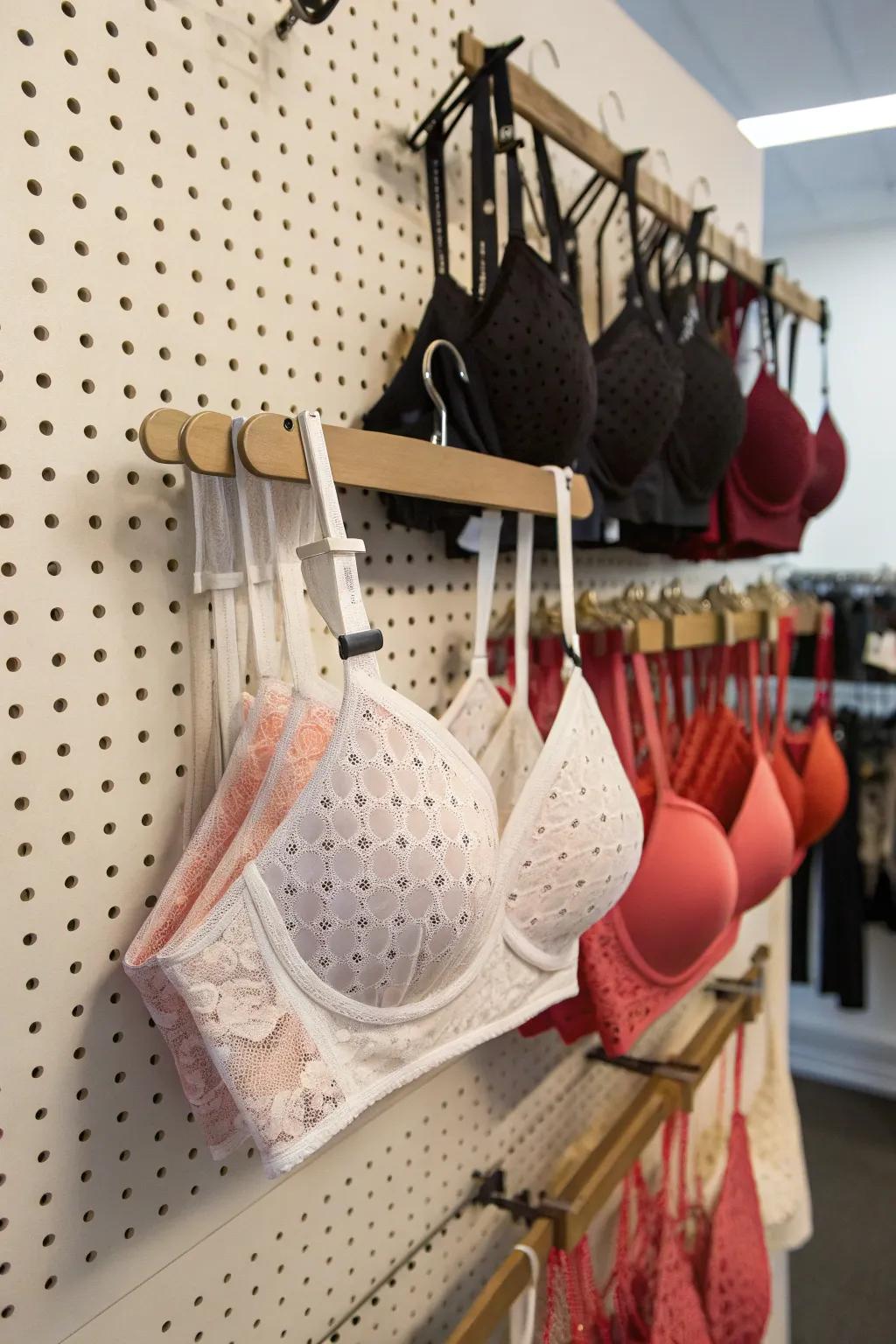 A pegboard provides a customizable and adaptable storage solution for bras.