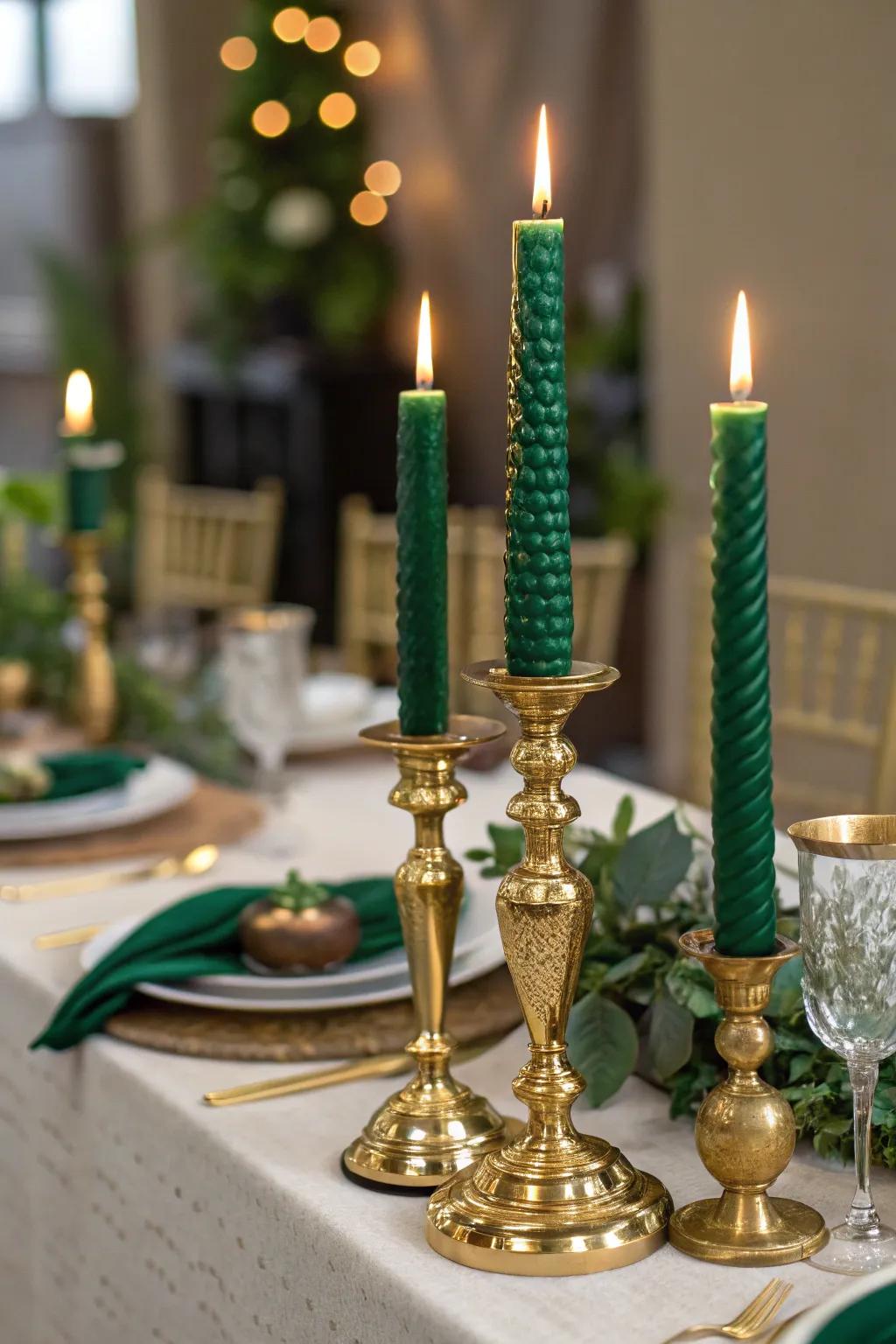 Gold candle holders paired with emerald green candles for a warm ambiance.