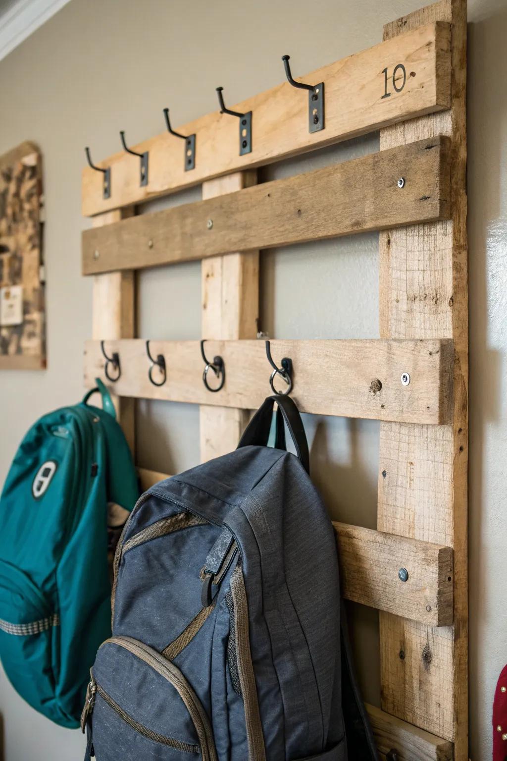 A wooden pallet offers rustic and cost-effective backpack storage.