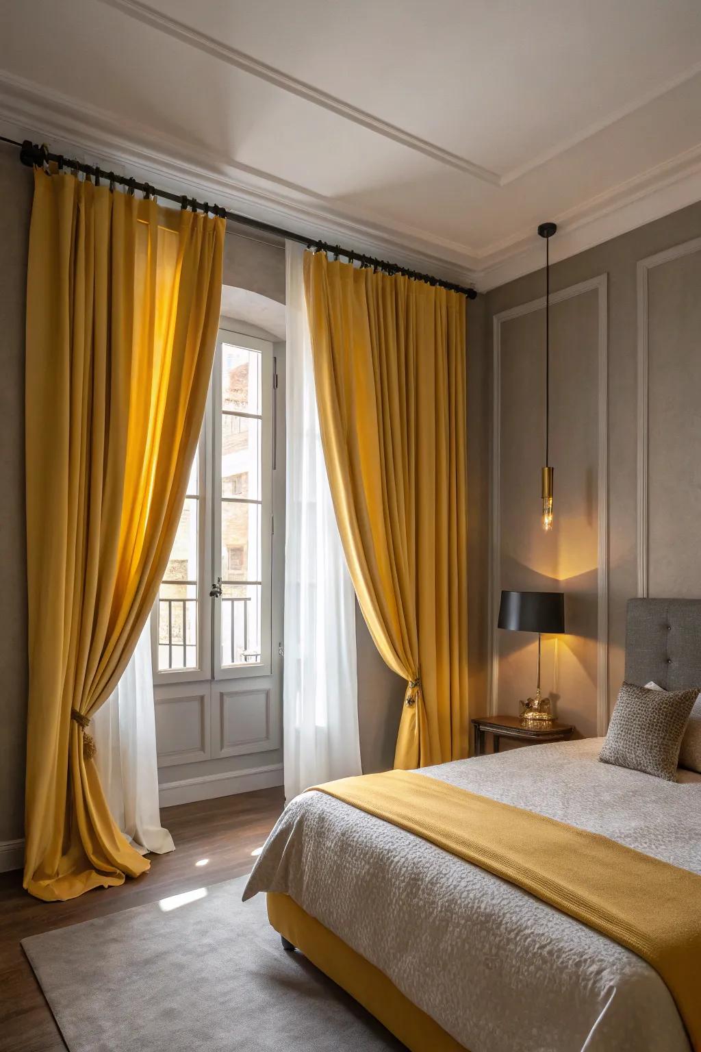 Yellow drapes add elegance and frame the windows in a grey-themed room.