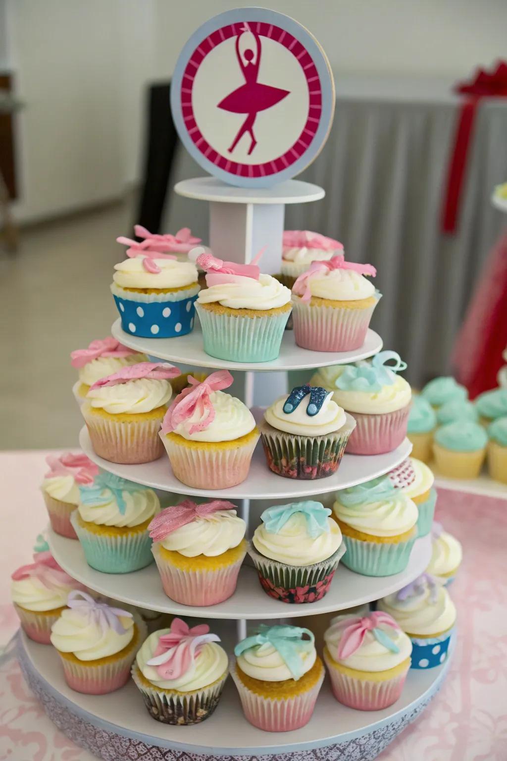 Cupcake tower with dance-themed toppers.