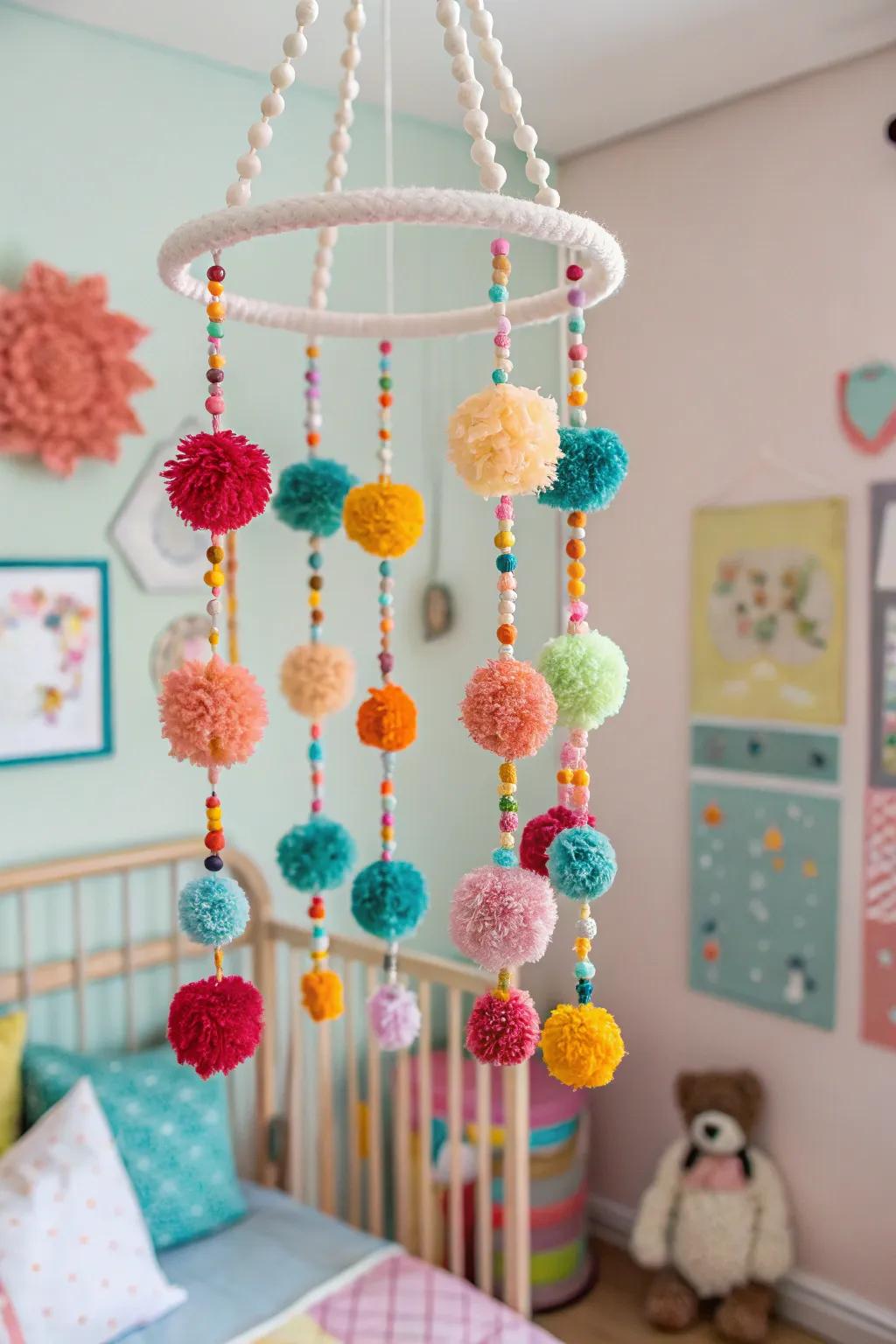 A playful yarn and pom-pom mobile adding cheer to a nursery.