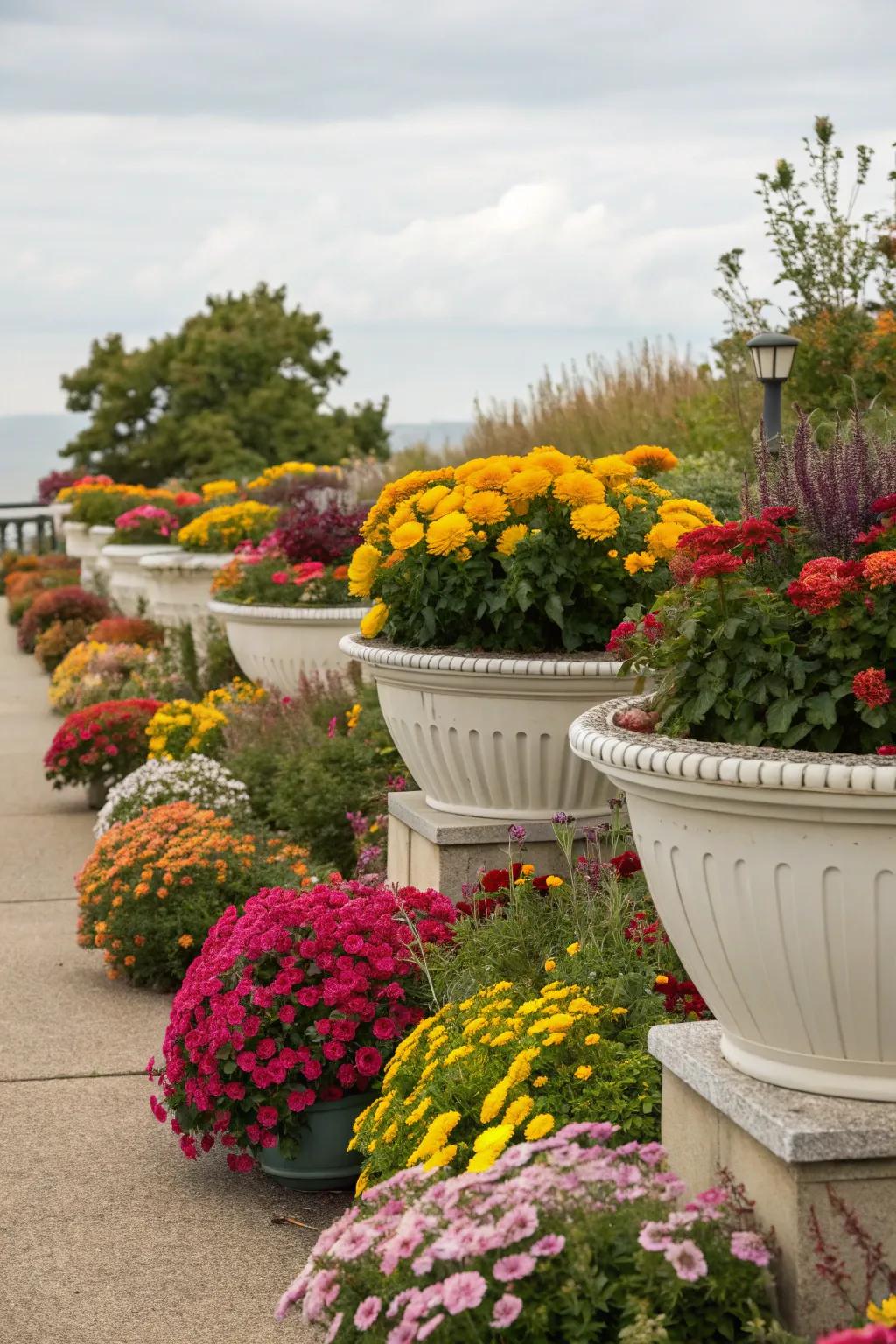 Seasonal containers add dynamic height and interest to flower beds.