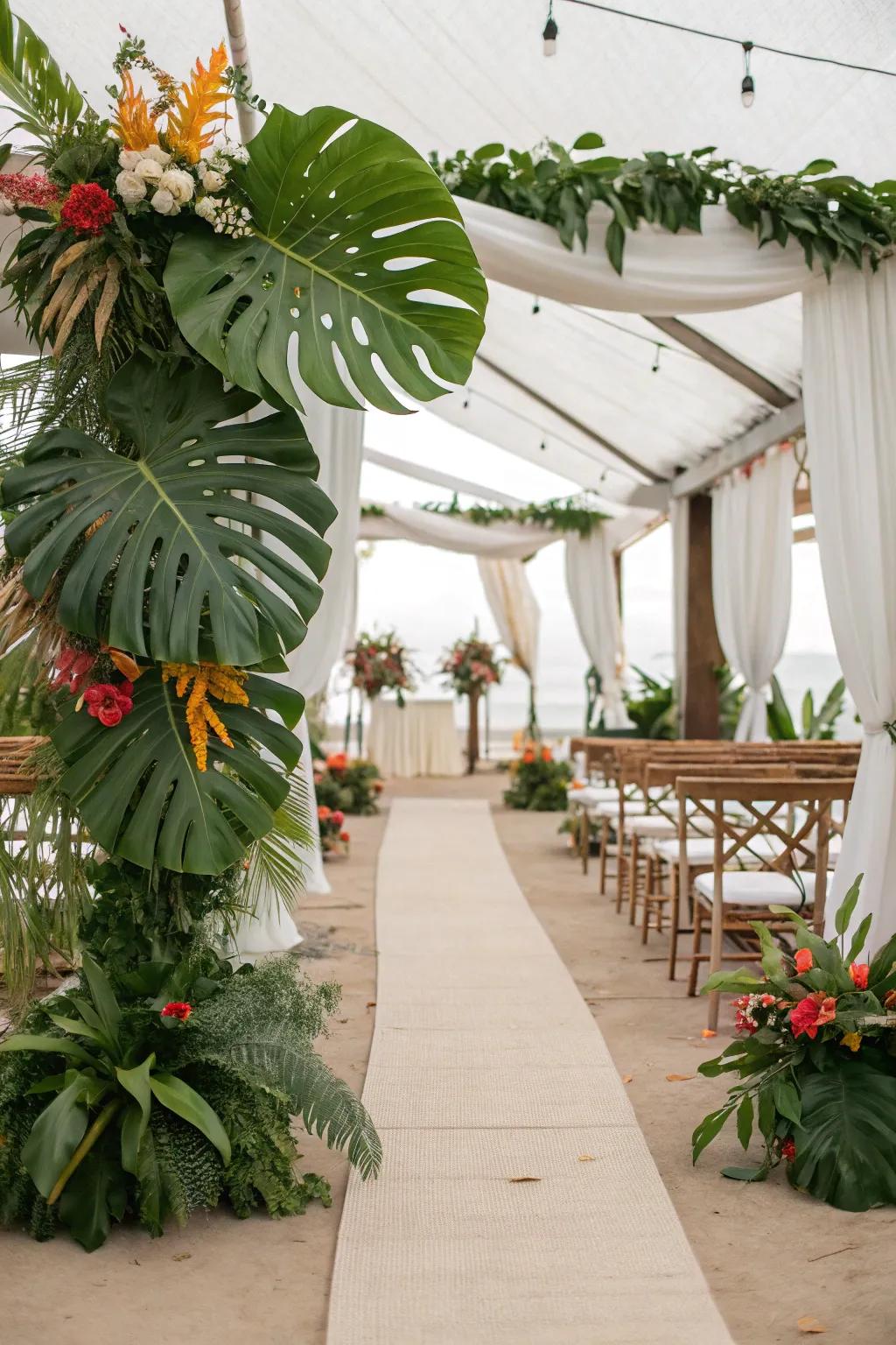 Tropical monstera leaves line a wedding aisle.