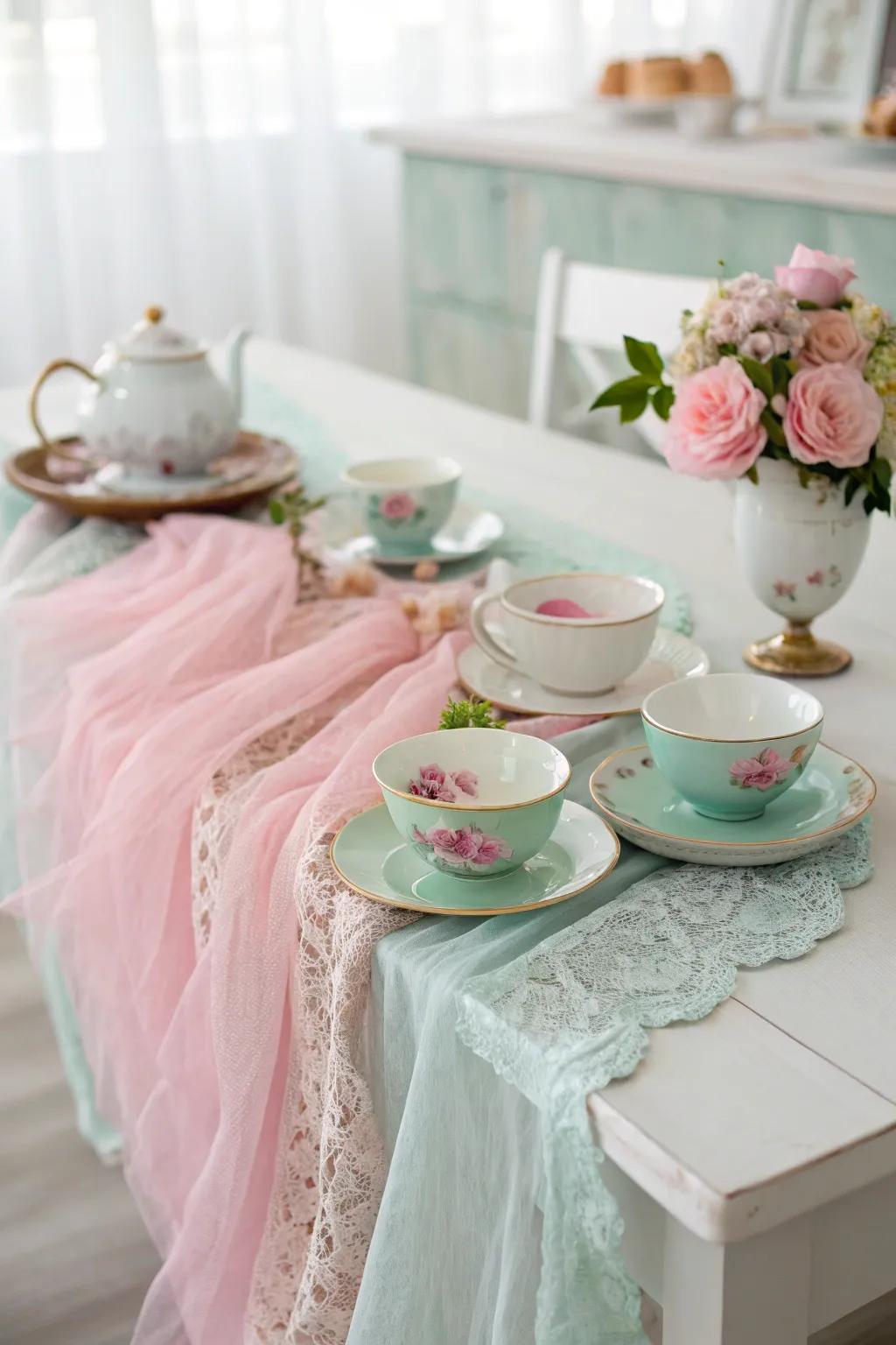 A vintage tea party setting with a pastel cheesecloth runner.