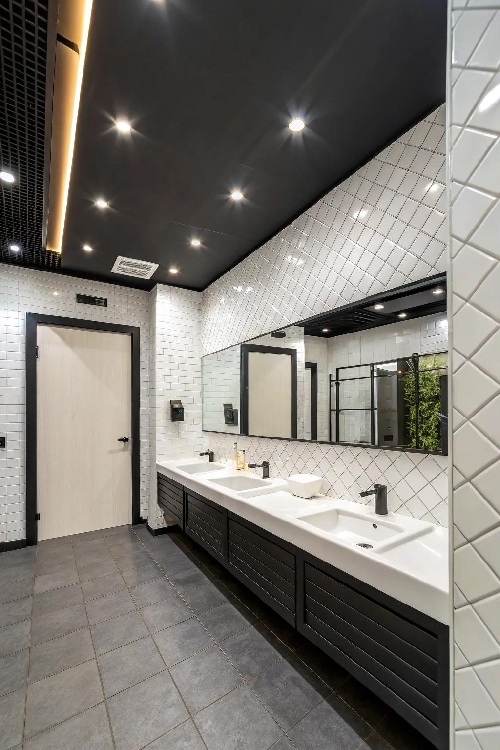 A modern washroom featuring a clean black ceiling contrasted with white tiles.