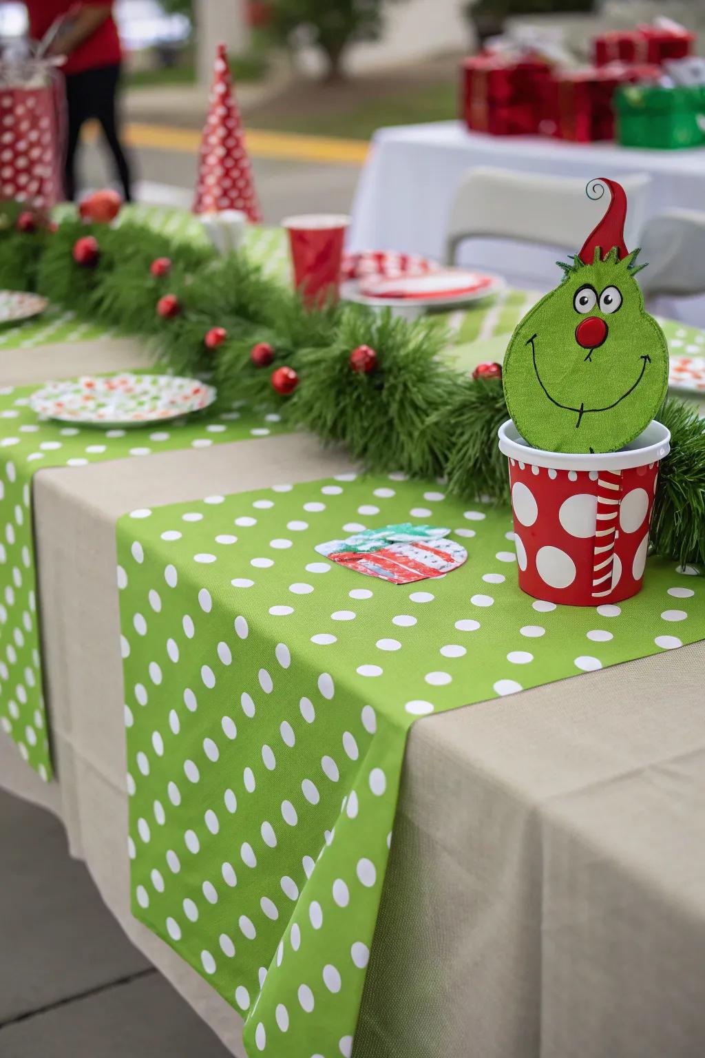 A green polka dot table runner adding charm to the Grinch-themed table.