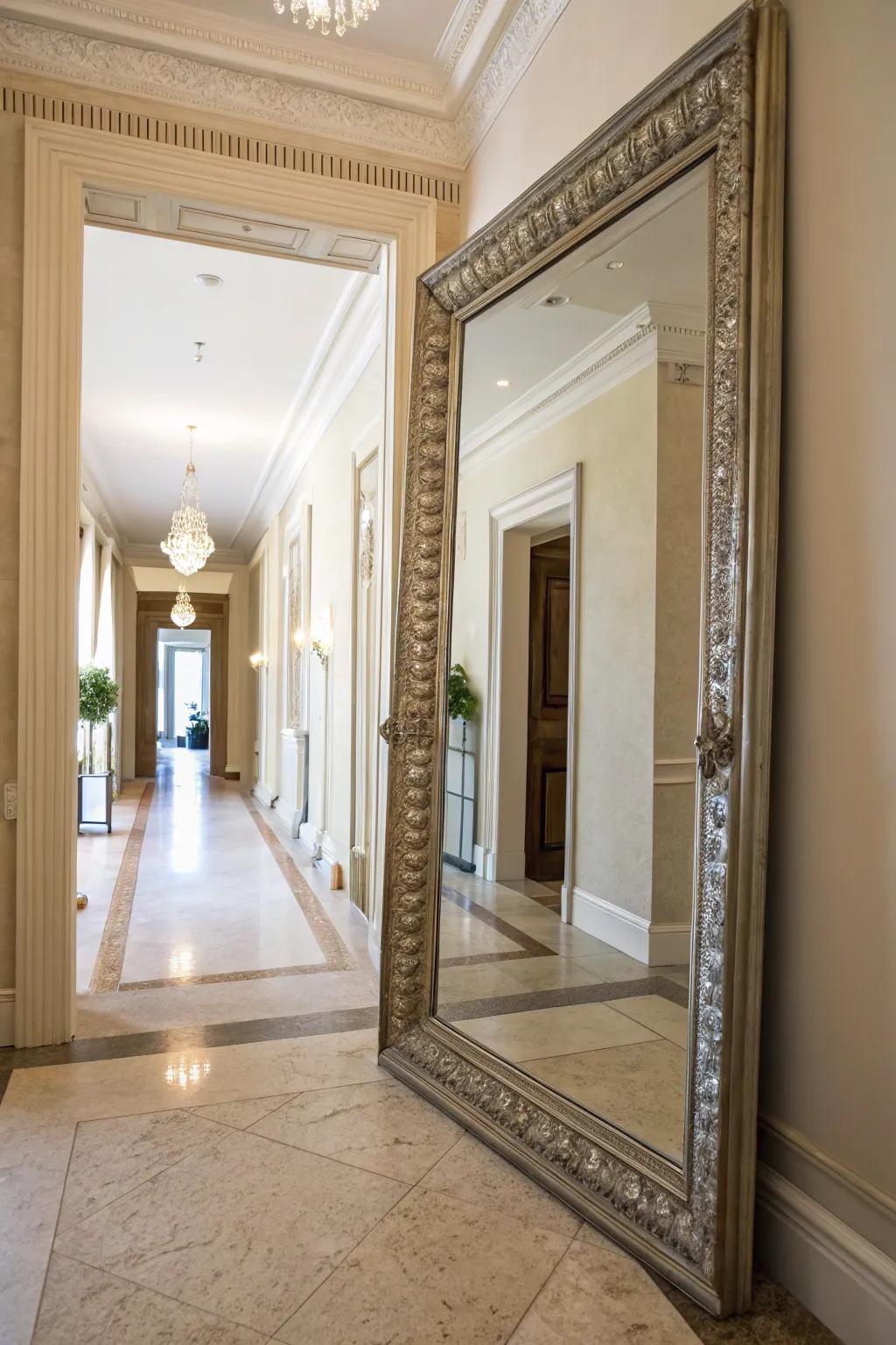 A decorative mirror reflects light, making the hallway appear more spacious.