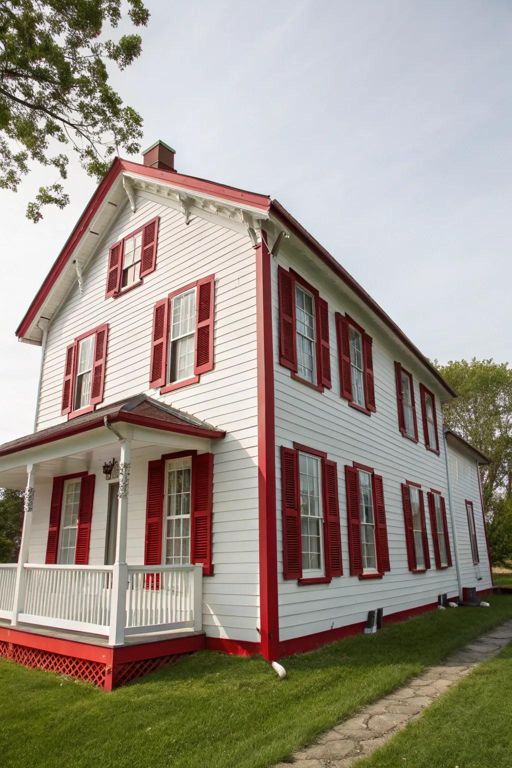 Red trim brings a lively and welcoming feel to this classic white home.