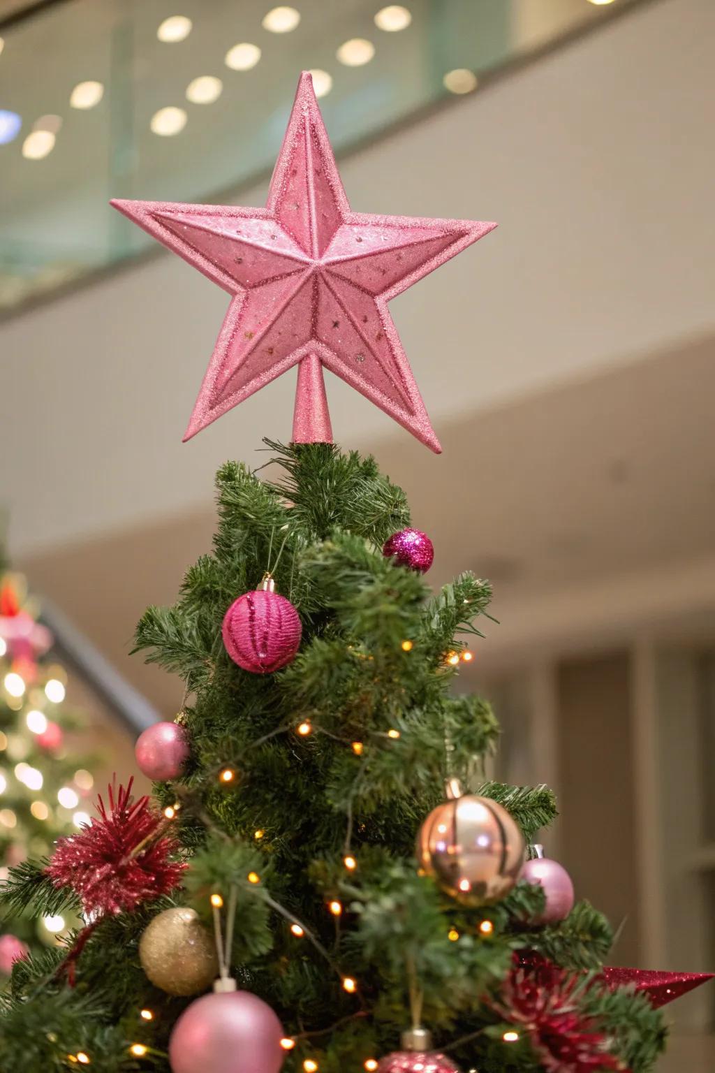 A pink tree topper completes your festive theme.