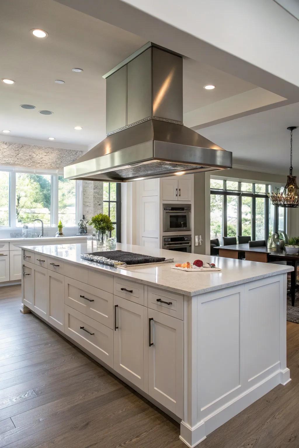 An open kitchen with a stainless-steel range hood over the island.