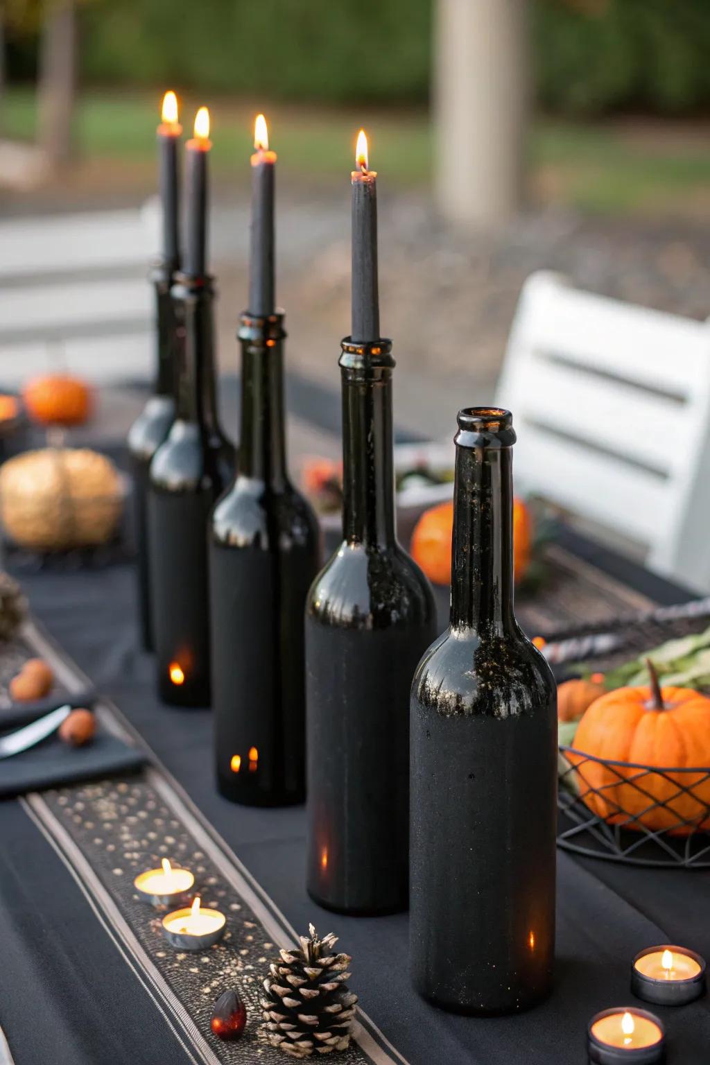 Halloween candlestick holders made from painted glass bottles.