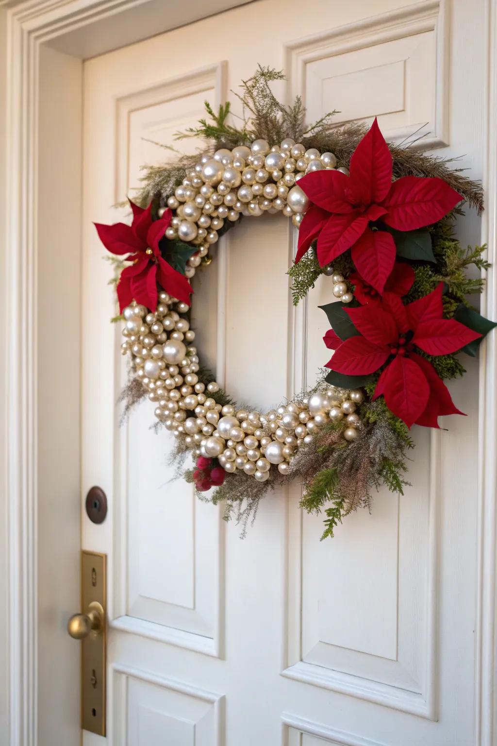 An elegant poinsettia and pearl wreath on a sophisticated door.