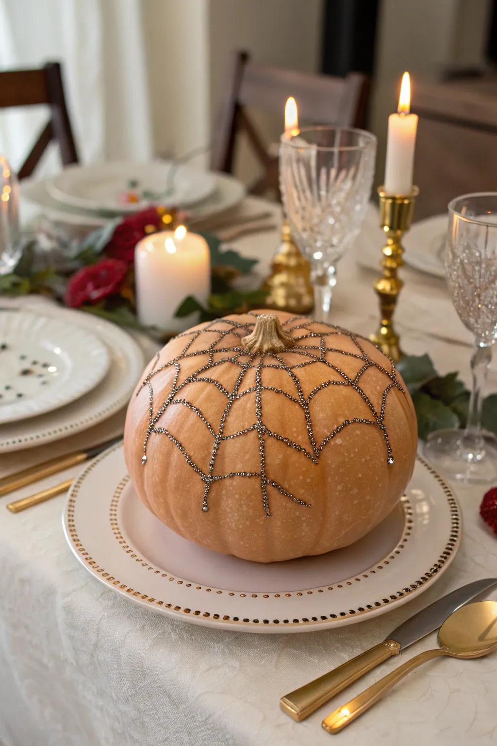 A pumpkin with a sparkling glitter-sprayed web.