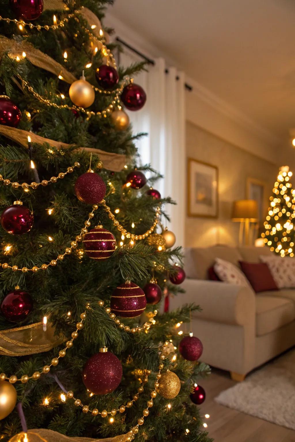 Deep burgundy and gold create a rich and luxurious Christmas tree theme.