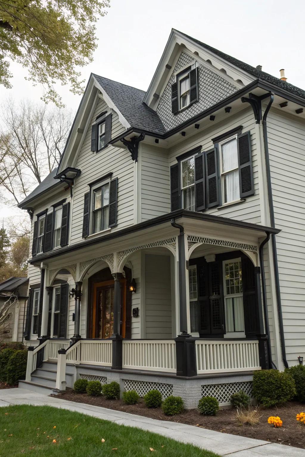 A colonial-style home featuring a mix of light and dark grey, accented with black trim.