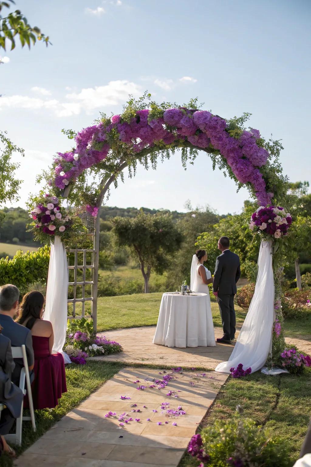 A wedding arch beautifully adorned with purple flowers.