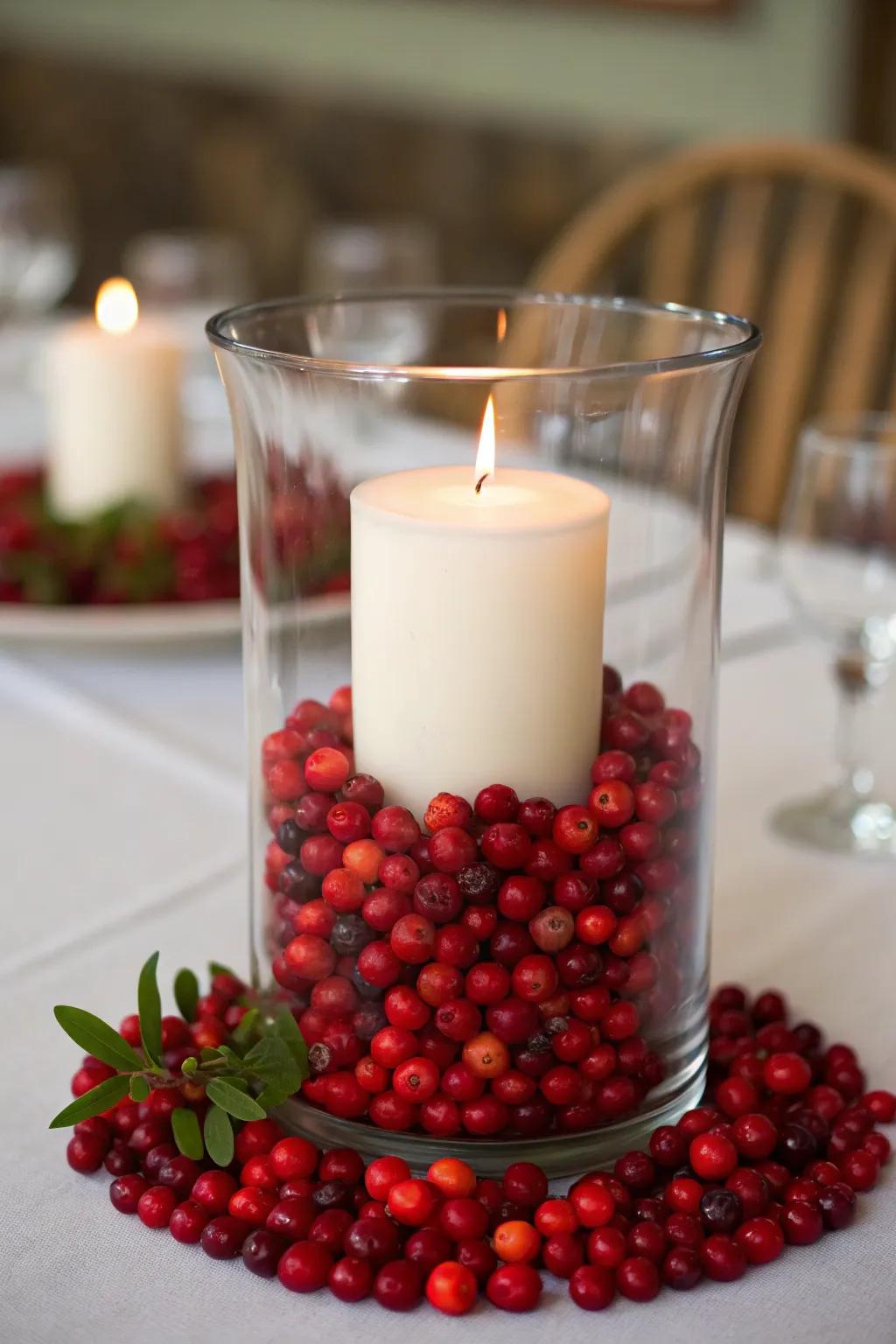 Vibrant red berries bring a pop of color to this hurricane centerpiece.