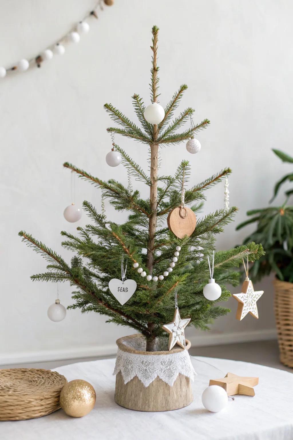 A minimalist Scandinavian mini Christmas tree with white and wooden ornaments.