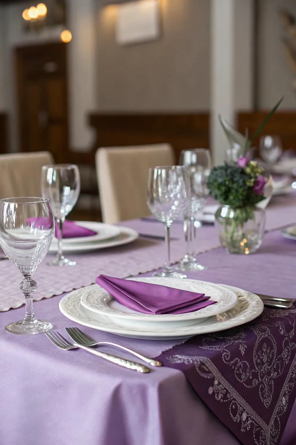 A reception table elegantly set with purple linens.