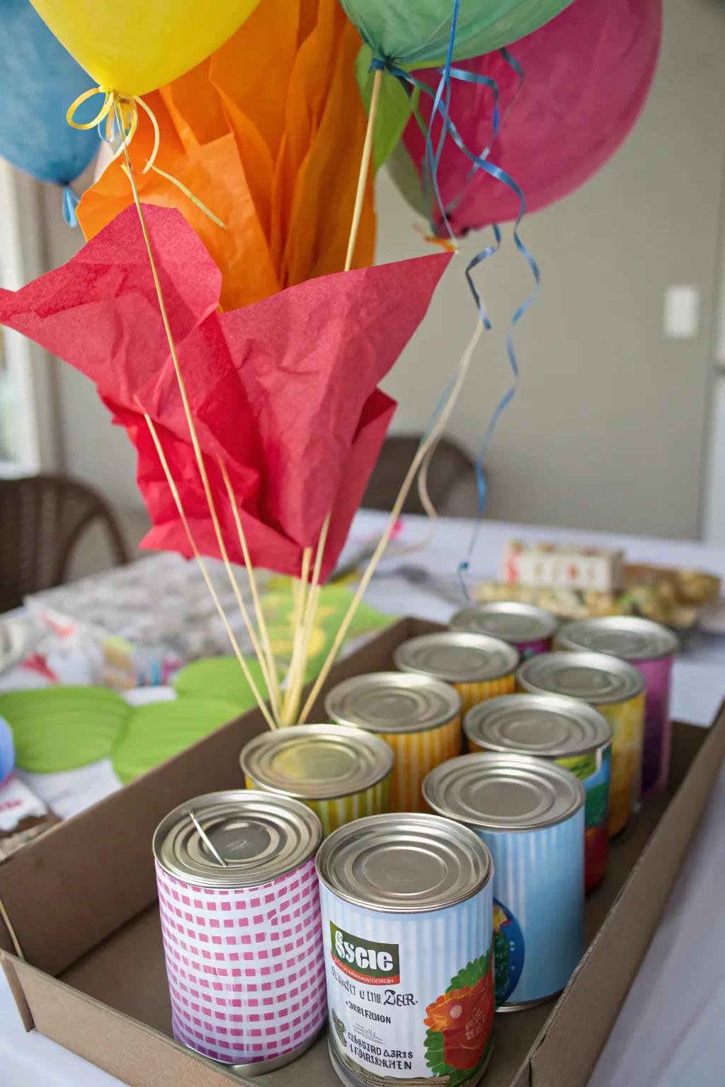 Creative use of canned goods as balloon weights, wrapped in festive materials.