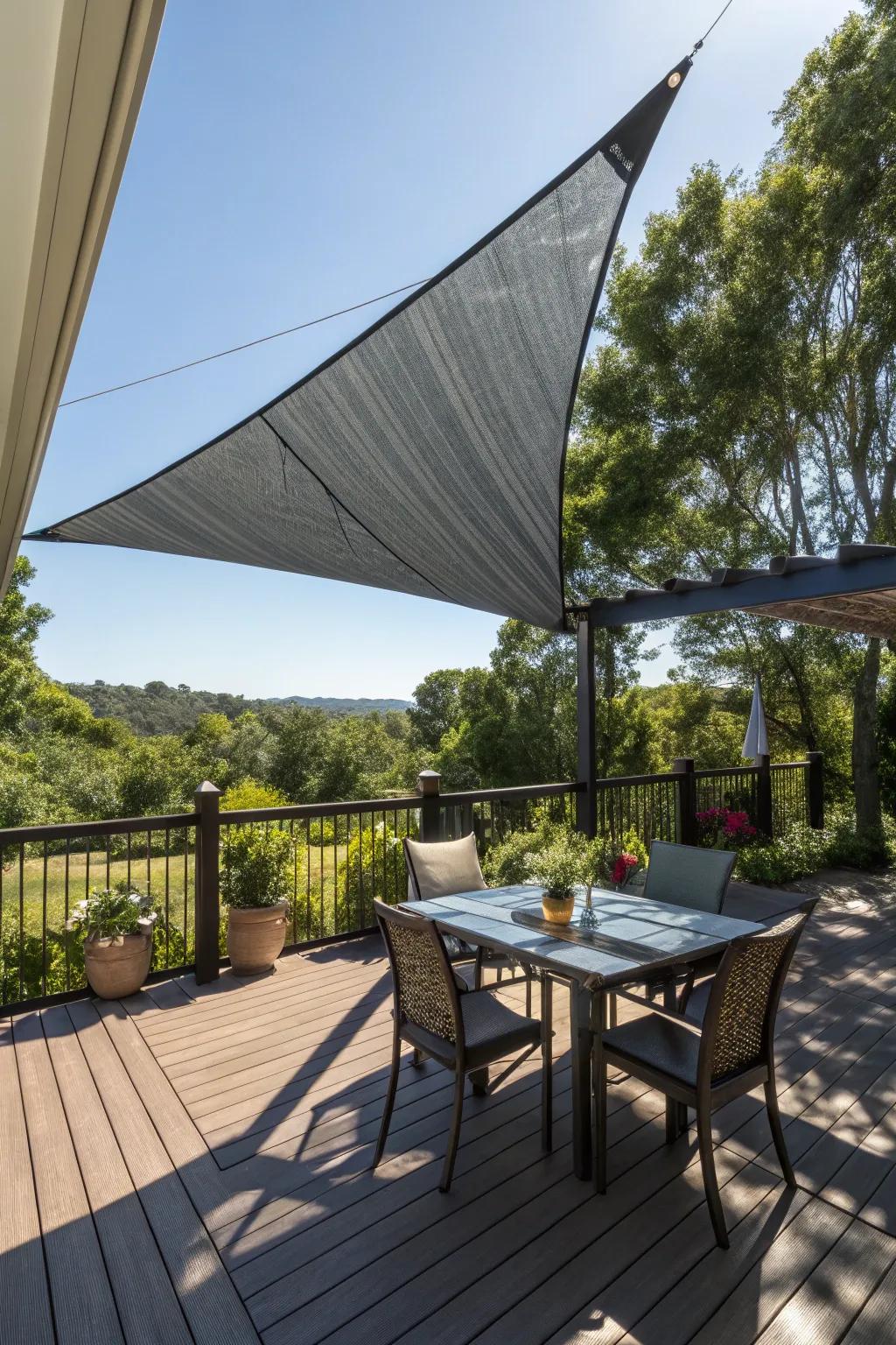 A shade sail adds dramatic flair and practical shade to this stylish deck.