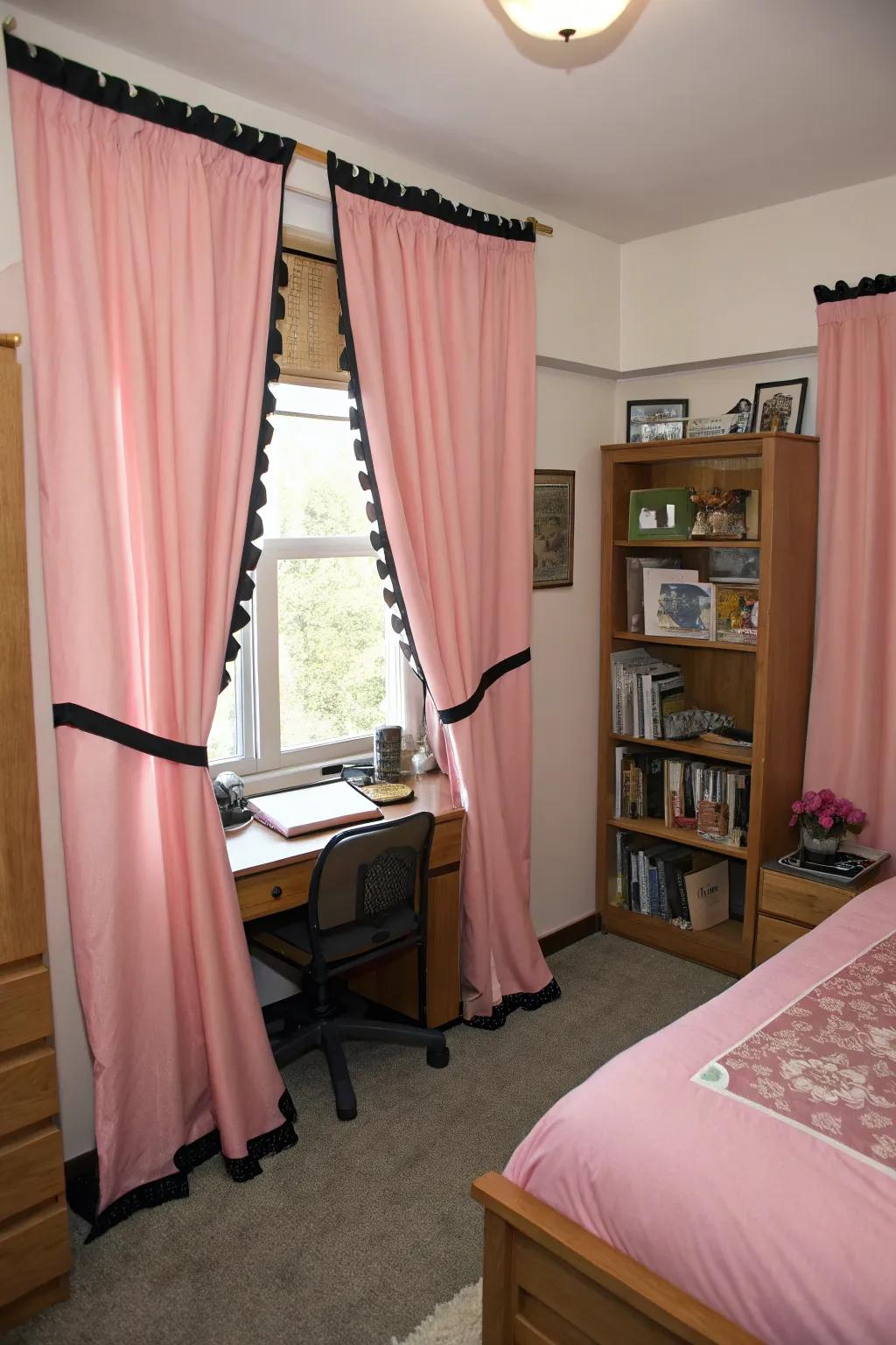 Elegant pink curtains with black trims in a dorm room.