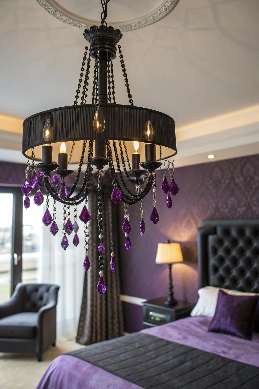 A stunning chandelier that serves as a focal point in a purple and black bedroom.