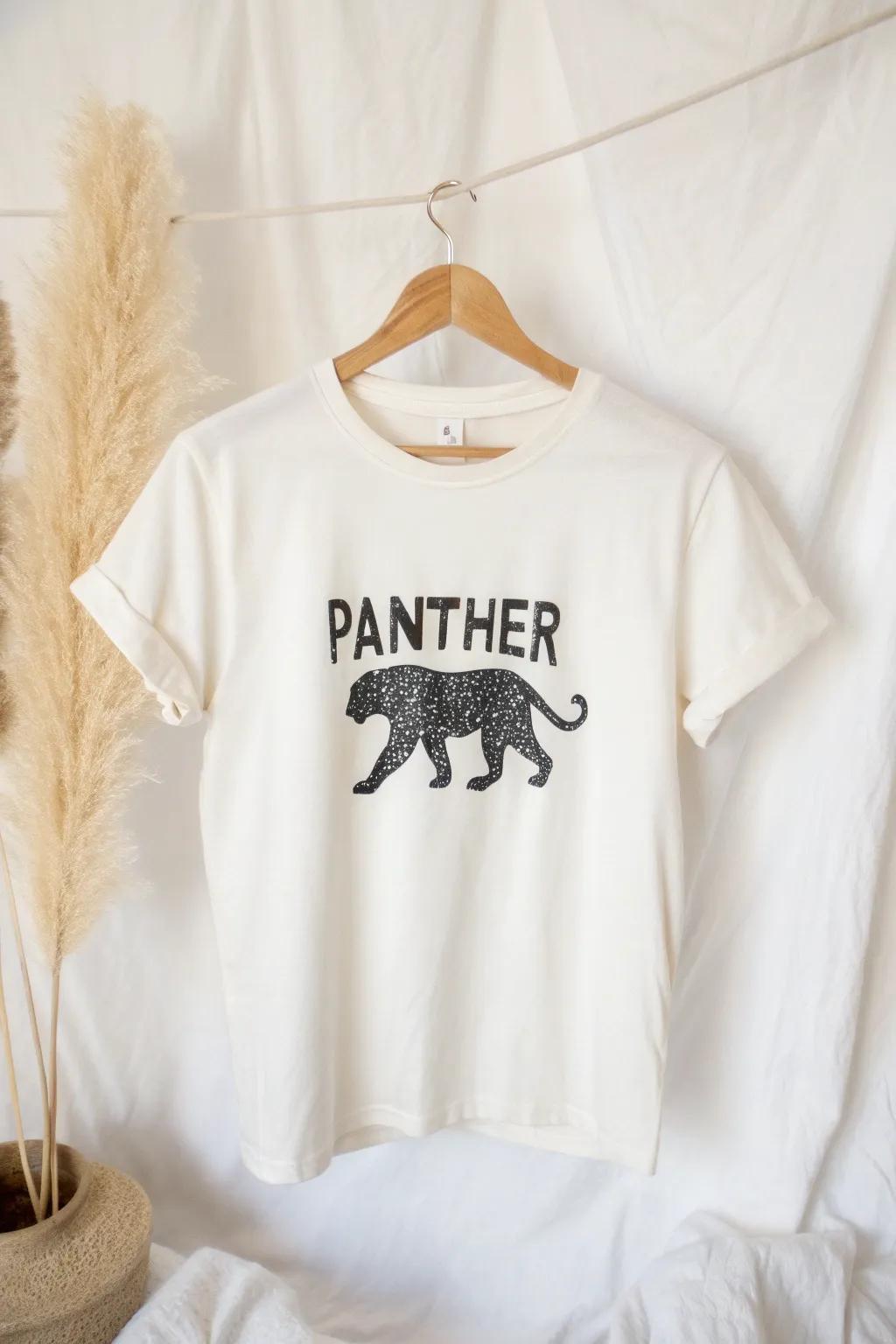 Unleash your wild side with a typographic panther shirt, where words craft a fierce silhouette.