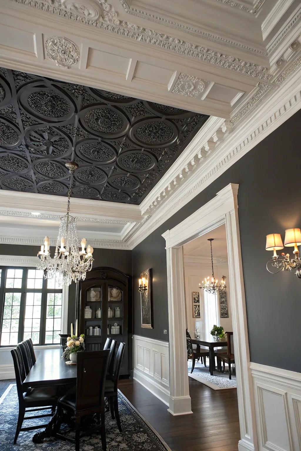 A dining room with a molded black ceiling that highlights white crown molding.